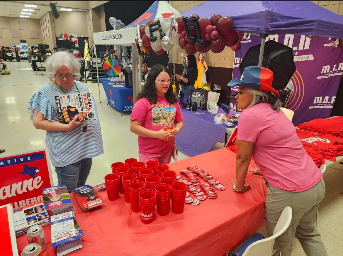 Conversation at the PAC outreach table during Fiestas 58.